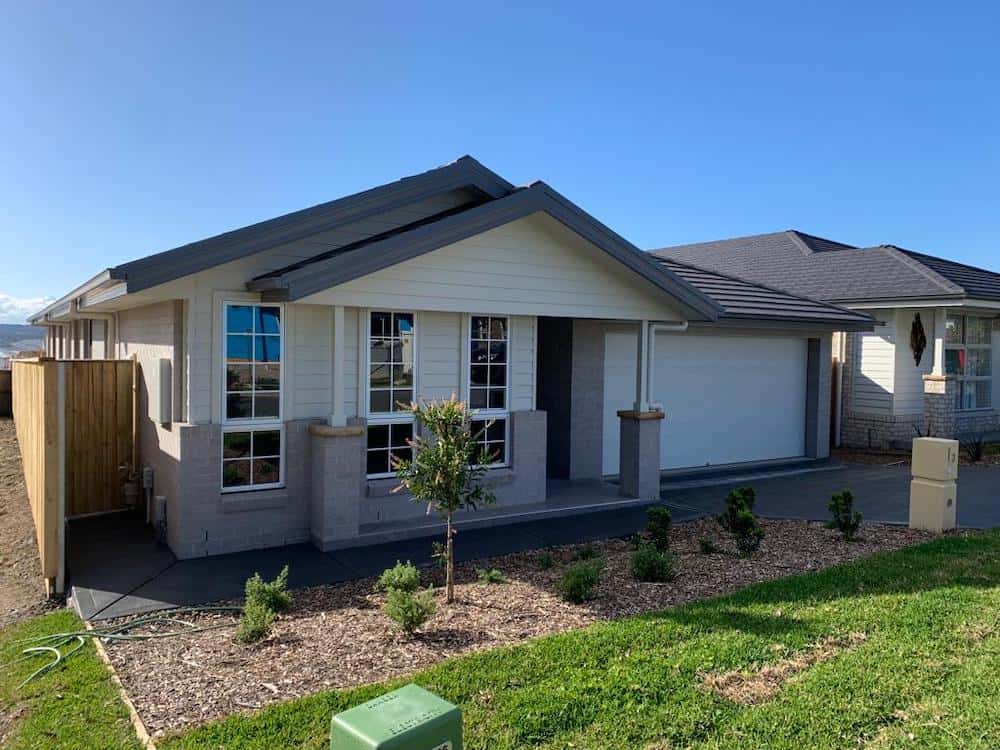A modern, single-storey house on a sunny day.