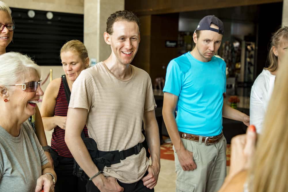 A group of people standing in what appears to be a lobby.